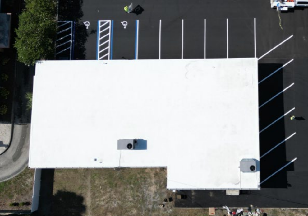 Together Credit Union — after re-build, aerial view of completed white roof and new parking lot